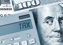 Tax. Benjamin Franklin looking calculator on One Hundred Dollar Bill.